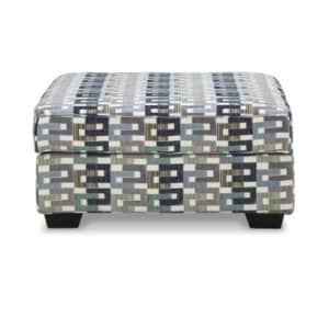 "Chic Suite Ottoman in stylish chenille, featuring a sturdy frame and plush cushioning. Perfect for modern, elegant spaces. Includes accent touches."