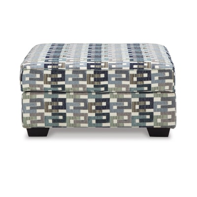 "Chic Suite Ottoman in stylish chenille, featuring a sturdy frame and plush cushioning. Perfect for modern, elegant spaces. Includes accent touches."