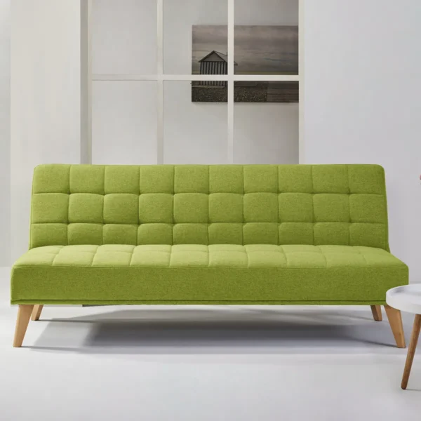 A lime green Aquila Click Clack sofabed with a quilted texture in a minimalist living room with white walls and a modern decor.