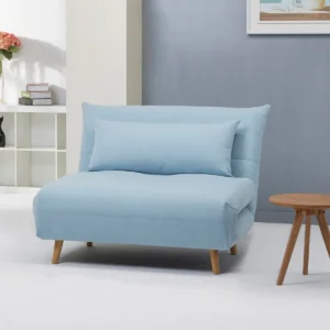 A light blue Carina Click Clack sofabed with wooden legs in a modern living room setting.