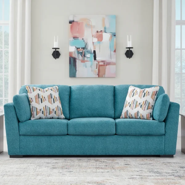 Living room setup featuring the Olivia sofa set in teal, complemented by stylish wooden coffee tables and modern decor.