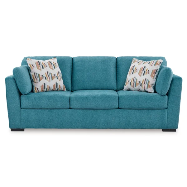 Front view of the Olivia 3-seater sofa with bold, patterned pillows, adding a pop of colour to a contemporary living room.