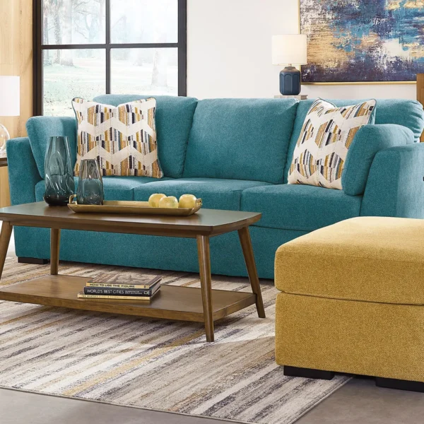 Olivia sofa and ottoman set in a bright living room with abstract wall art and modern furnishings.